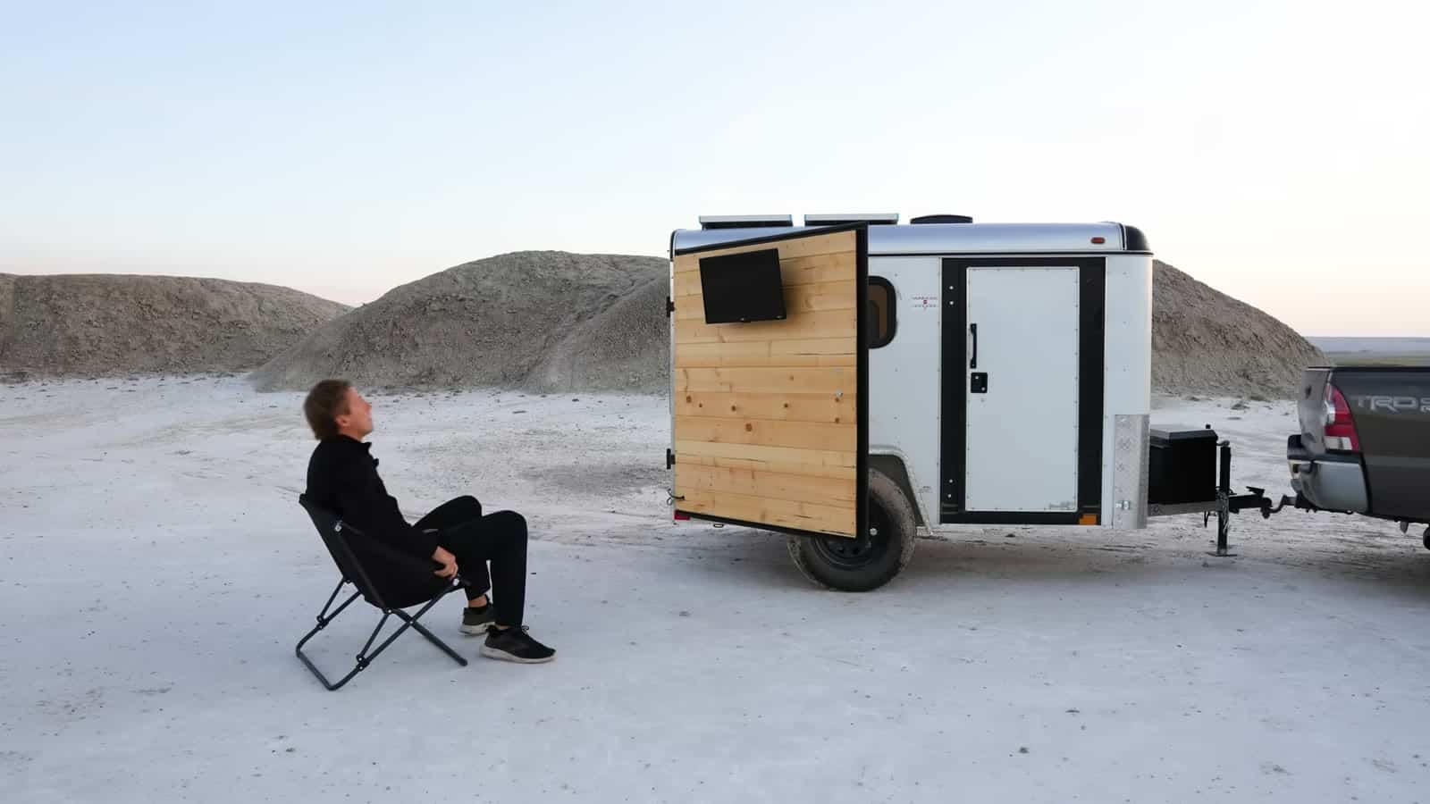 Outdoor movie night with a TV mounted on the open back door of the trailer in the South Dakota badlands