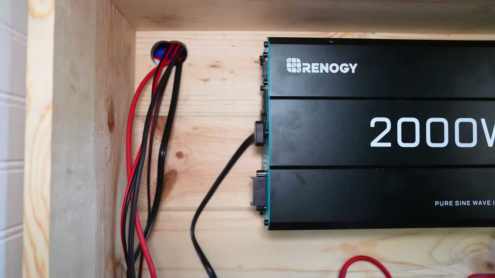 Renogy 2000W inverter and wiring mounted inside the cedar electrical cabinet