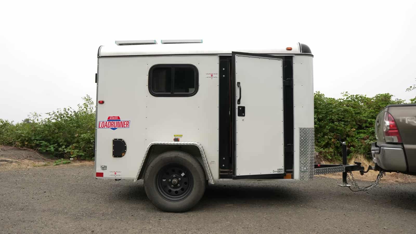 Side view of the white cargo trailer camper parked along the Oregon coast