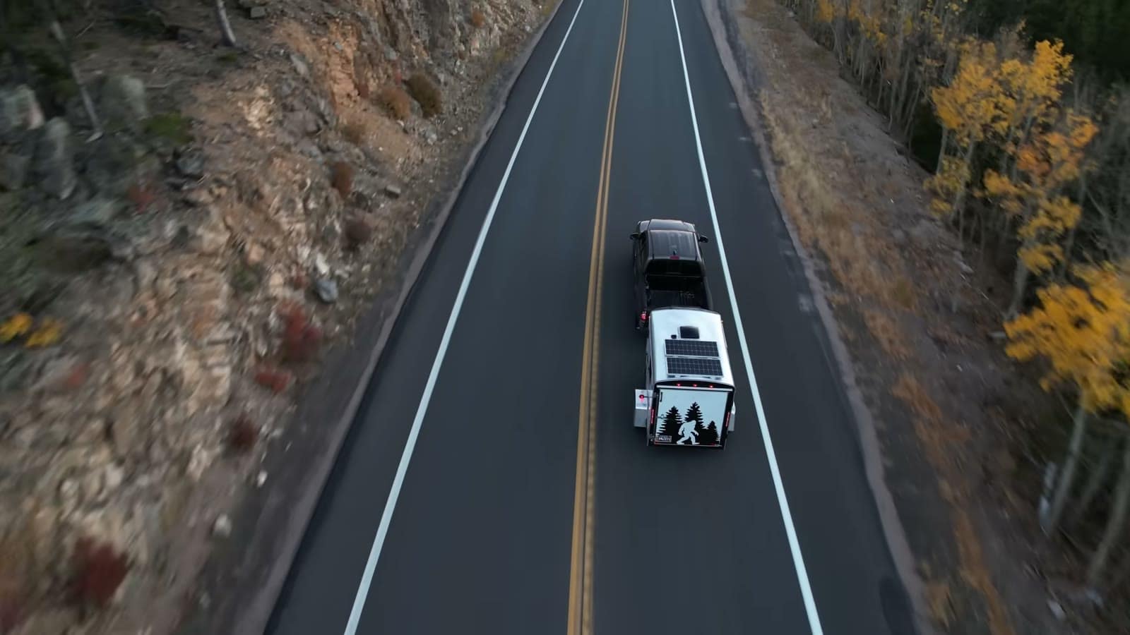 Overhead drone view of the finished trailer camper towed through Colorado fall color
