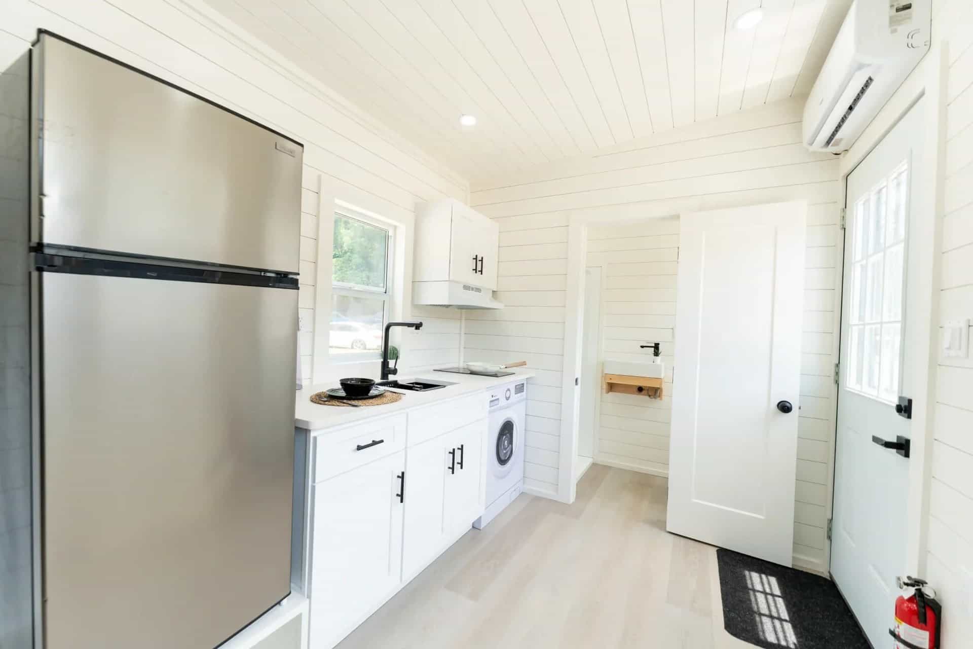 Fairfax gallery: kitchen run, bath doorway with vessel sink visible, entry door and mini-split