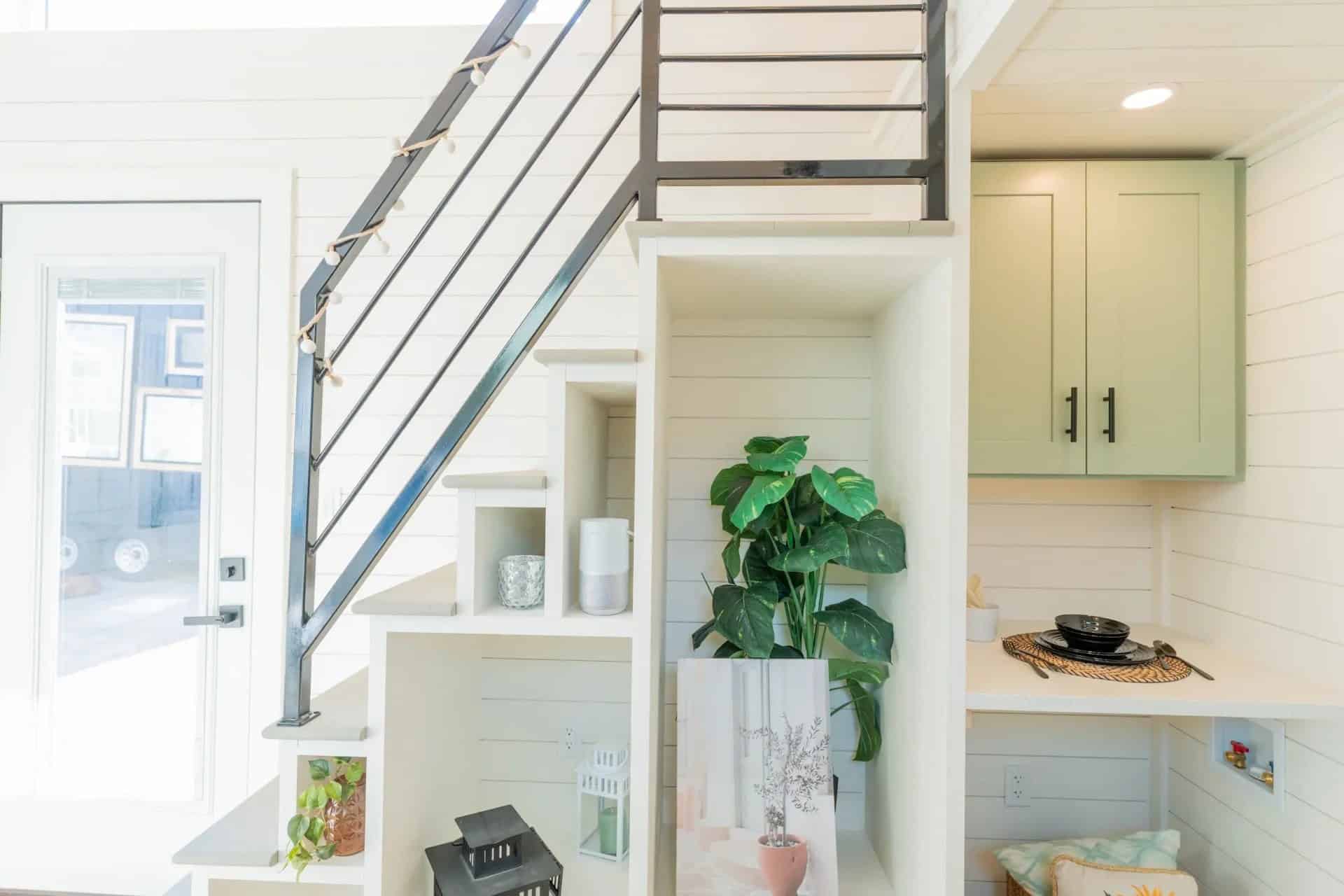Genesis gallery interior: stair cubbies, laundry hookups under a counter, sage upper cabinets — may be a prior Genesis build