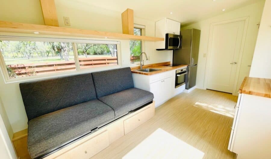 Cozy tiny house interior featuring a small kitchen and built-in seating area.
