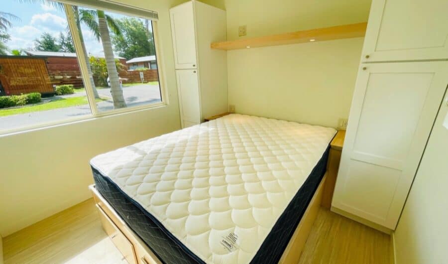 Interior view of the Tiny House eBoho XL at Palm Court, showcasing compact living and smart storage.
