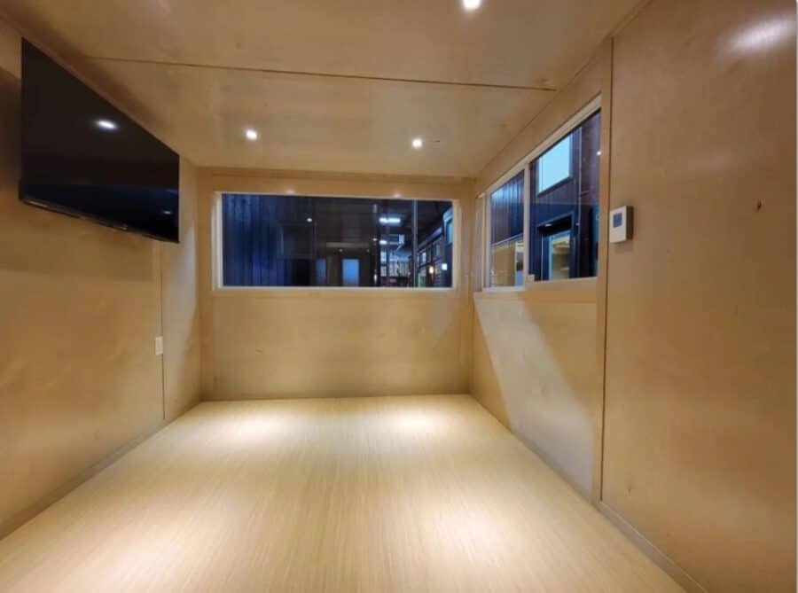 Bright interior of the eONE XL tall tiny house on clearance, showcasing spacious living area with la.
