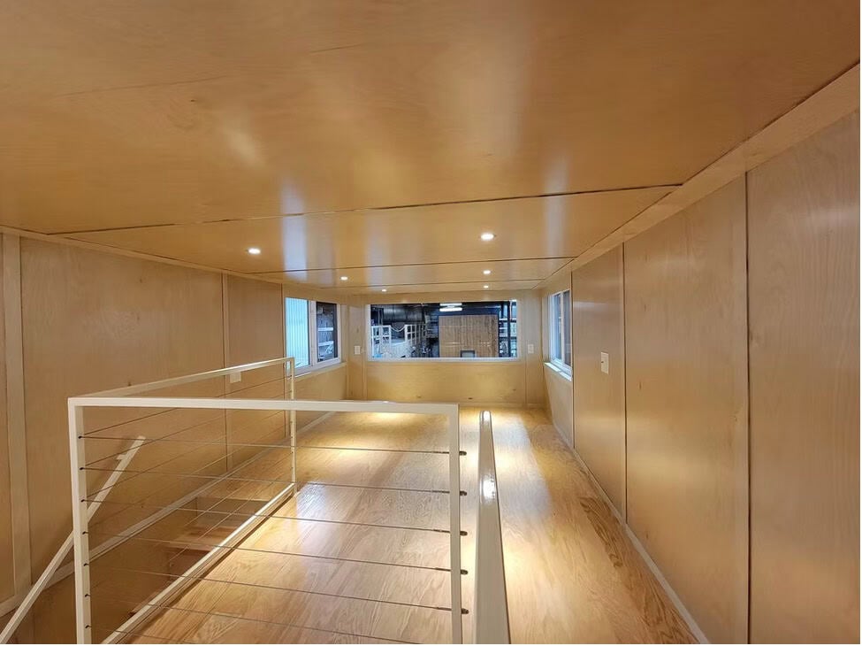 Expanded second-floor loft retreat with cable railing and walkway in the eONE XL