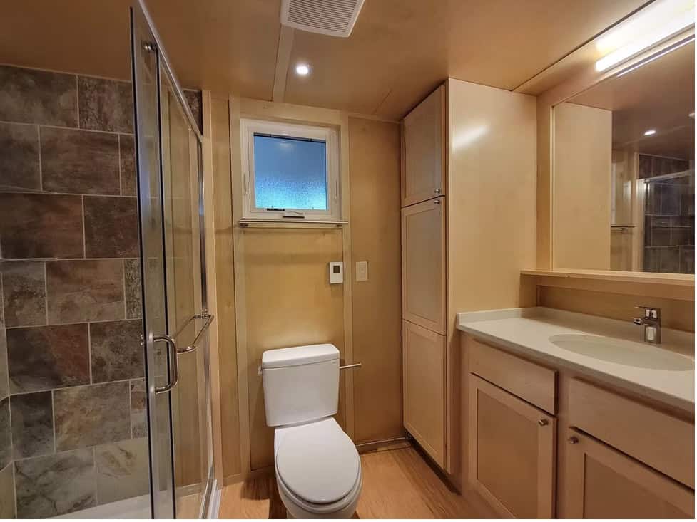Large bathroom in the Escape eONE XL with a tiled shower and quartz-topped vanity