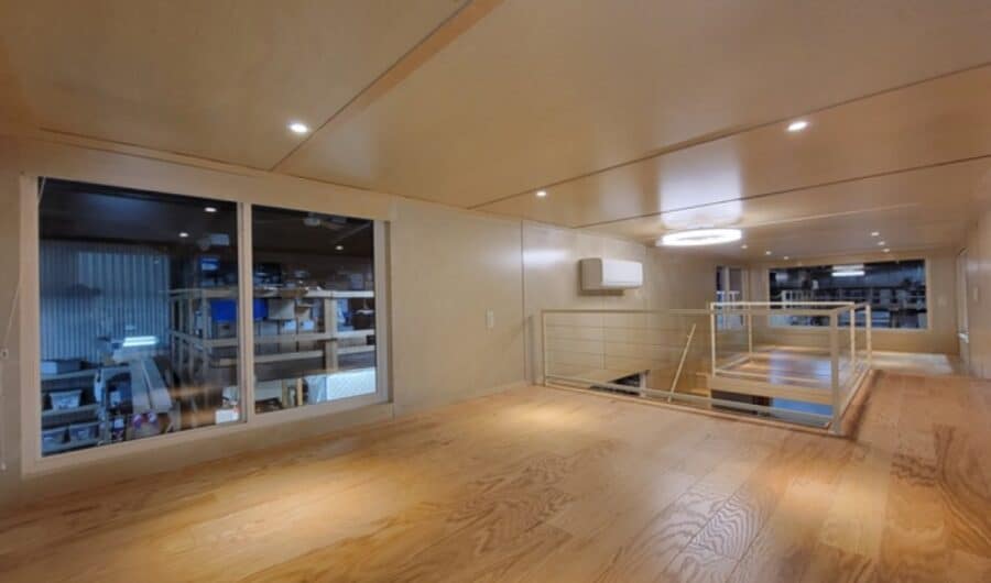 Interior view of a modern tiny house showcasing open space and minimalist decor.