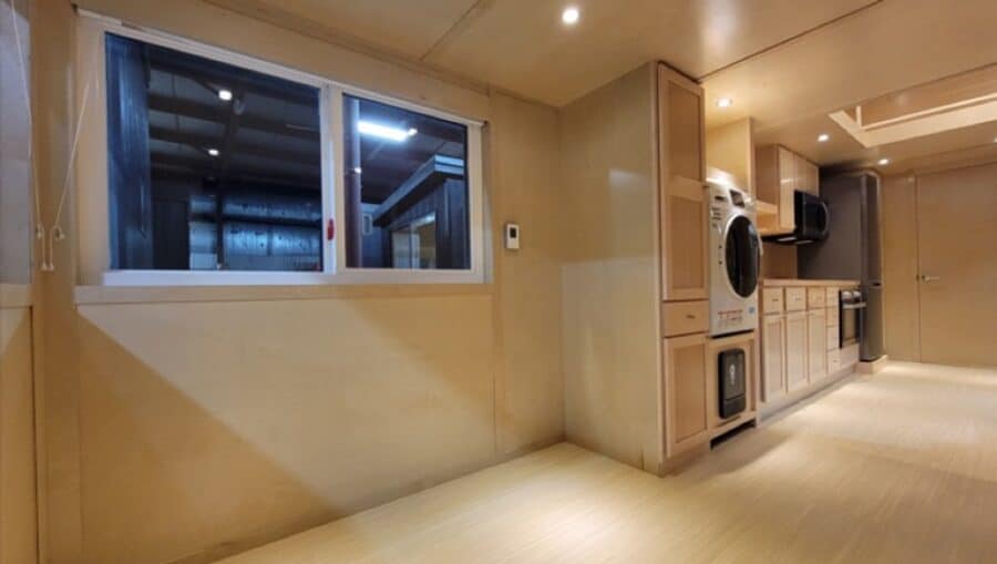 Full bathroom with walk-in shower and laundry center
