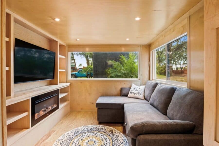 Cozy tiny house living room with large windows and modern decor at Escape Tampa Bay Village.