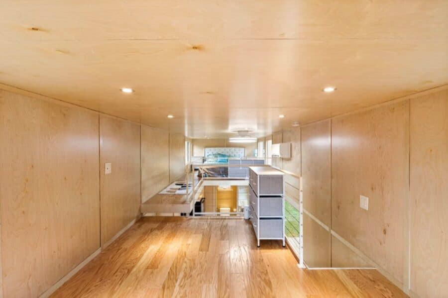 Compact tiny house kitchen with efficient storage and modern appliances.