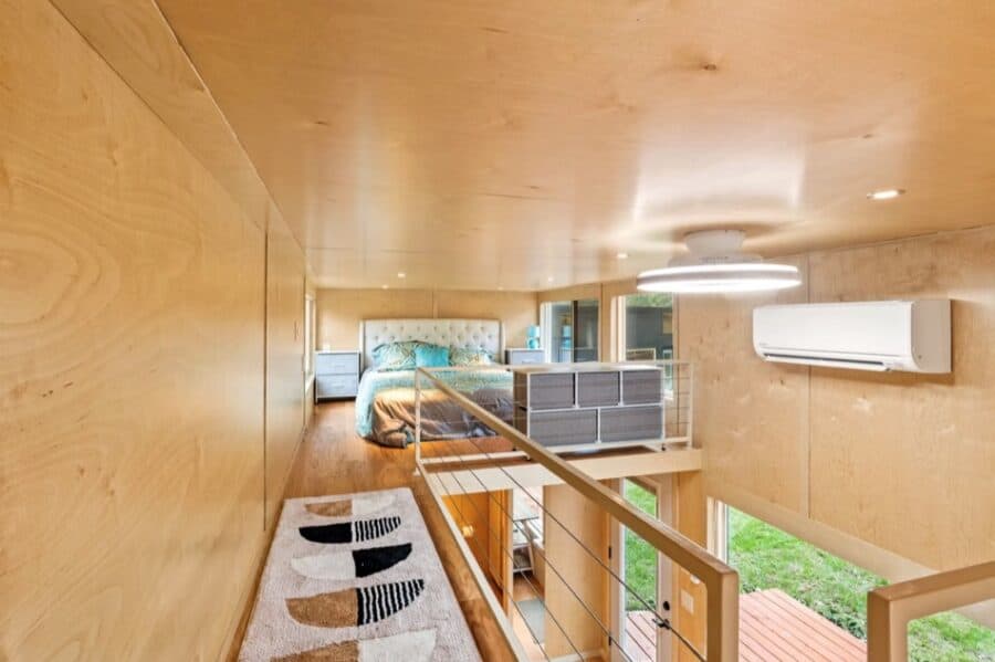 Compact tiny house interior with cozy sleeping area and modern amenities.