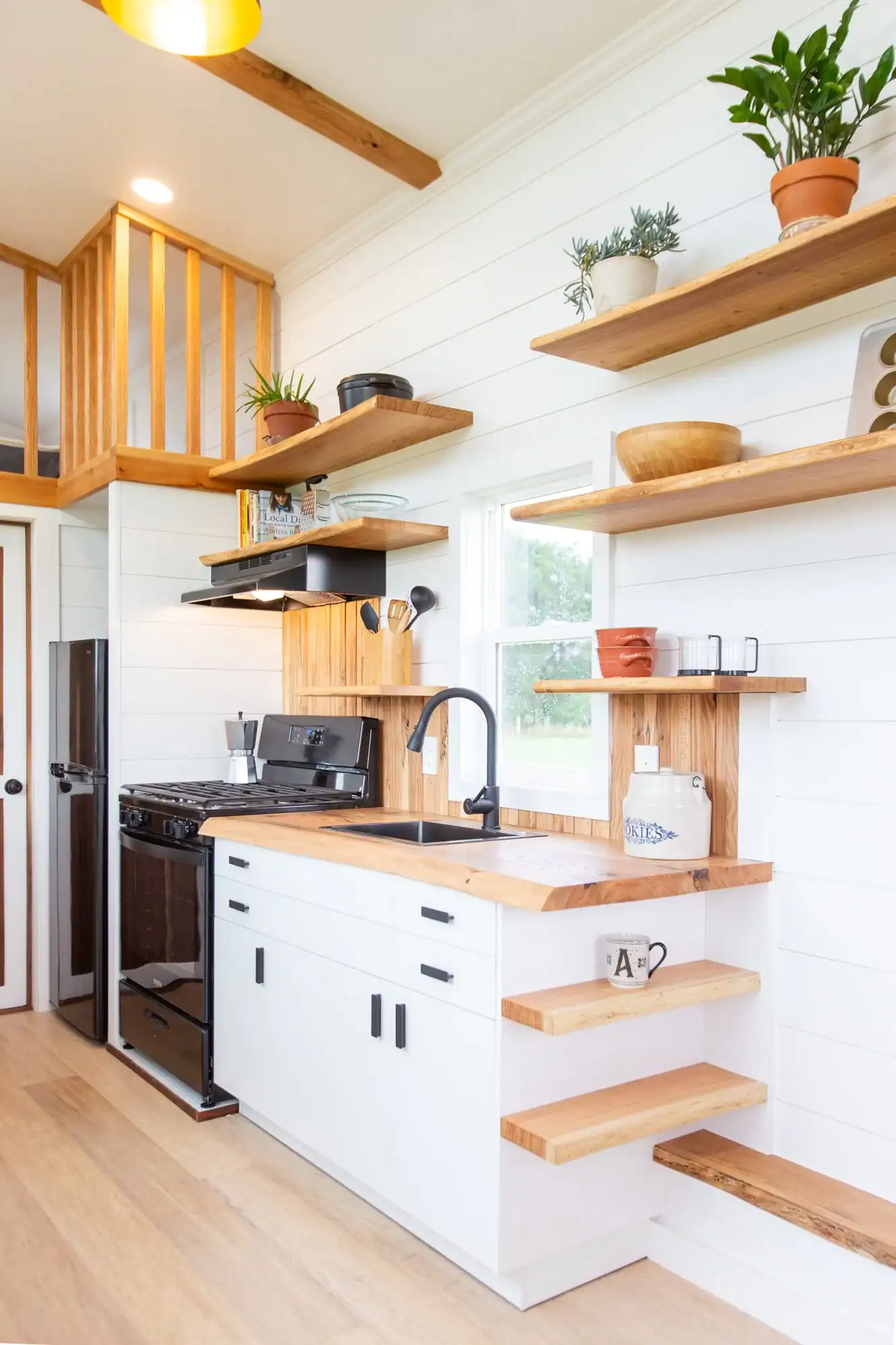 Tiny House Kitchen with Open Shelving and Natural Wood Accents