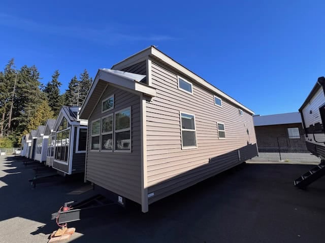 Elevation Woodland Loft park model exterior with taupe lap siding on the Wilder RV lot