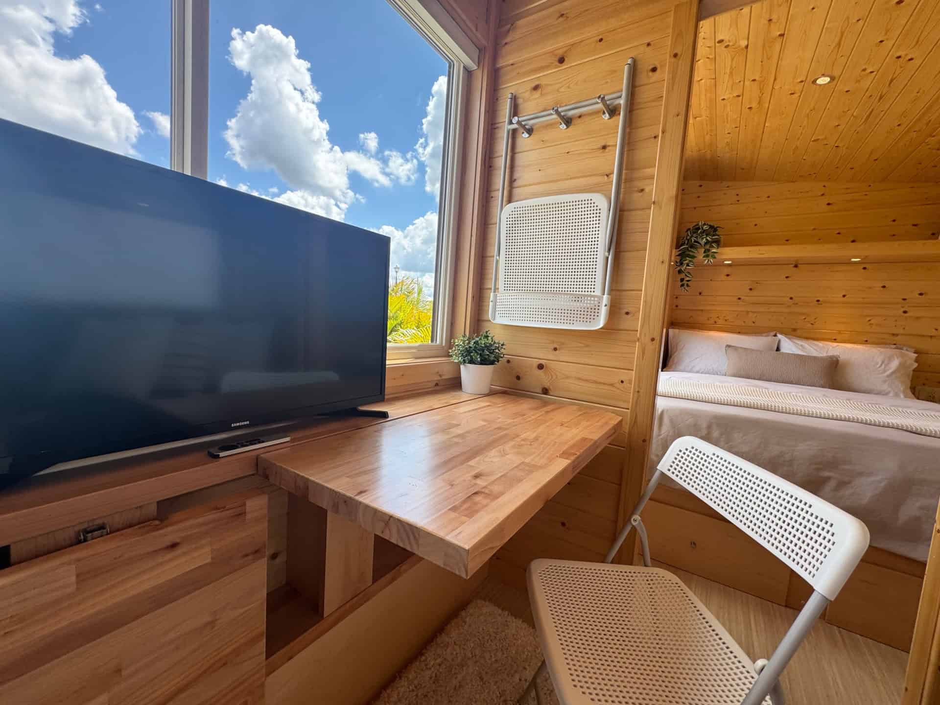 Fold-down desk and dining table with TV in the Escape Boho XL tiny house