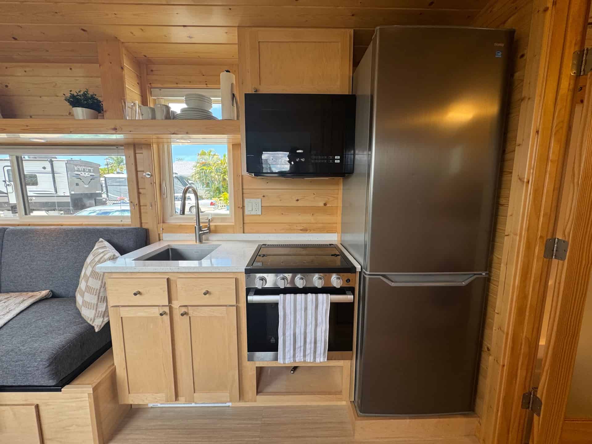 Full kitchen with stainless appliances in the Escape Boho XL tiny house