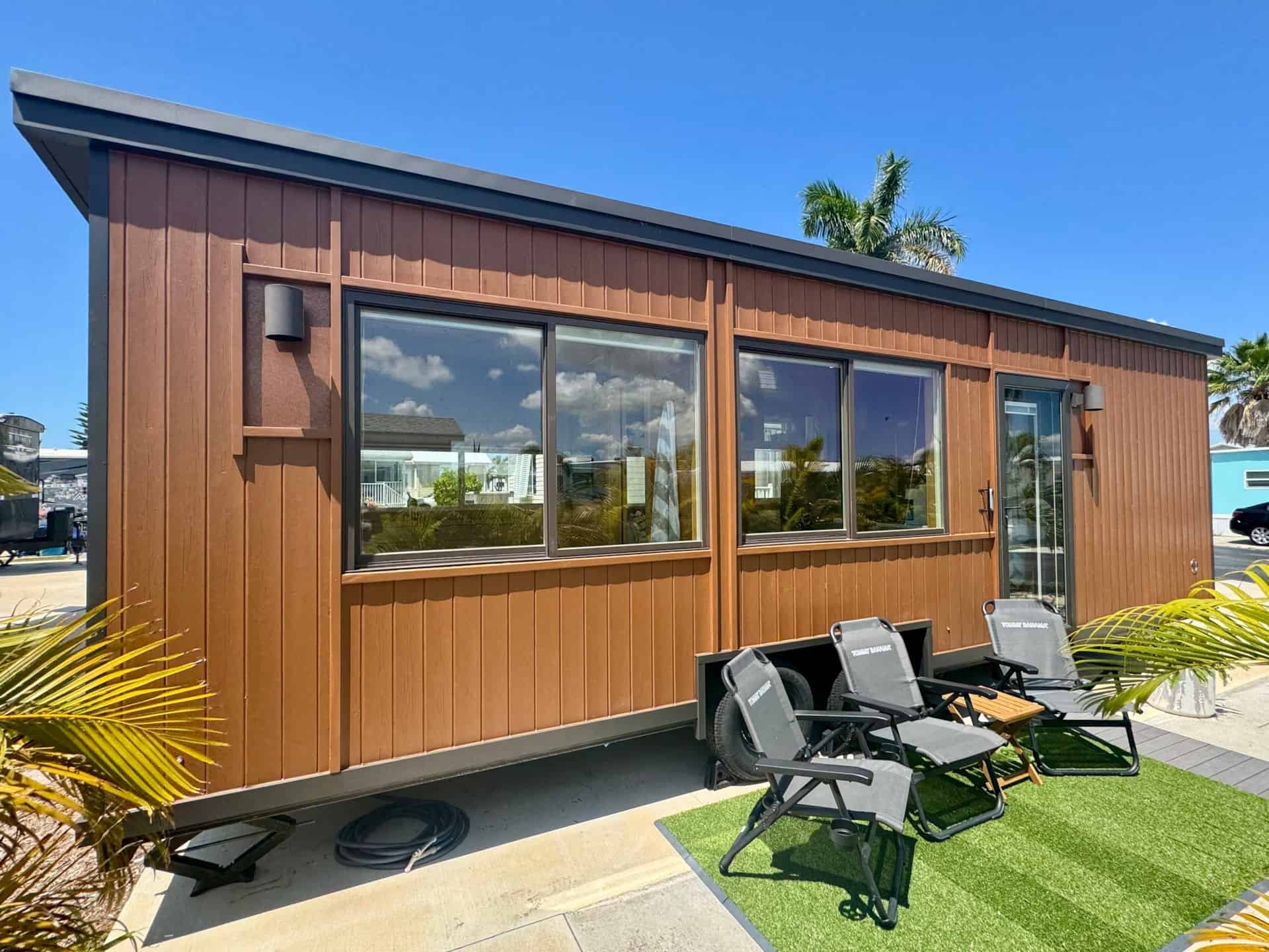 Escape Boho XL tiny house with outdoor patio and lounge chairs