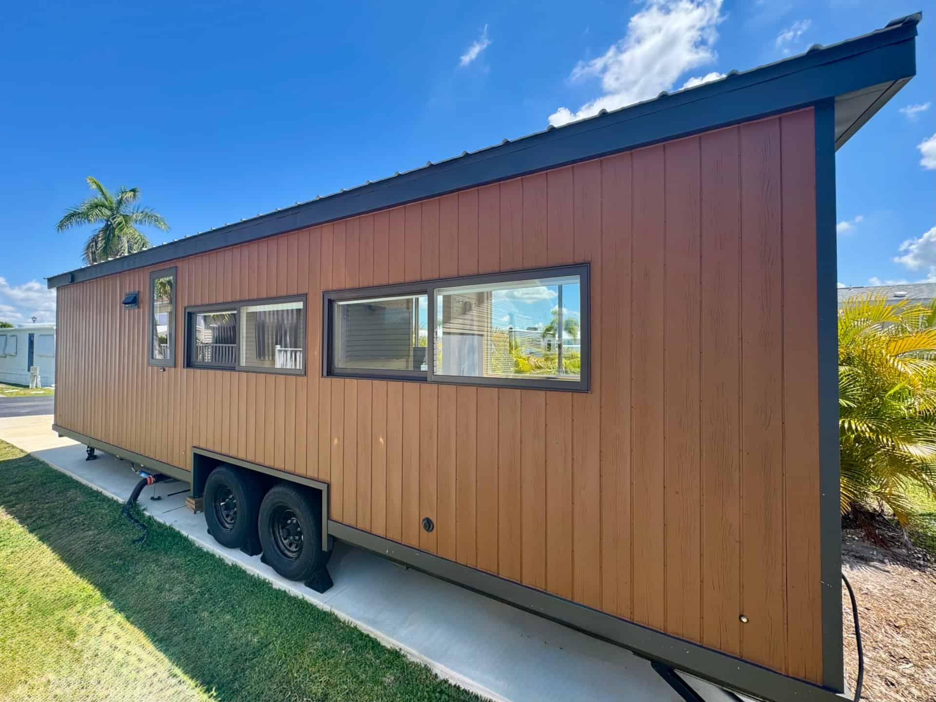 Side profile of the Escape Boho XL tiny house on its custom dual-axle trailer