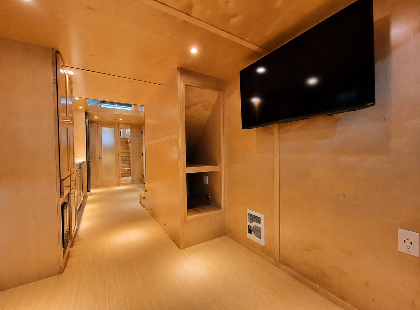 Escape eONE Limited living area showing the wall-mounted Smart TV and built-in storage nook