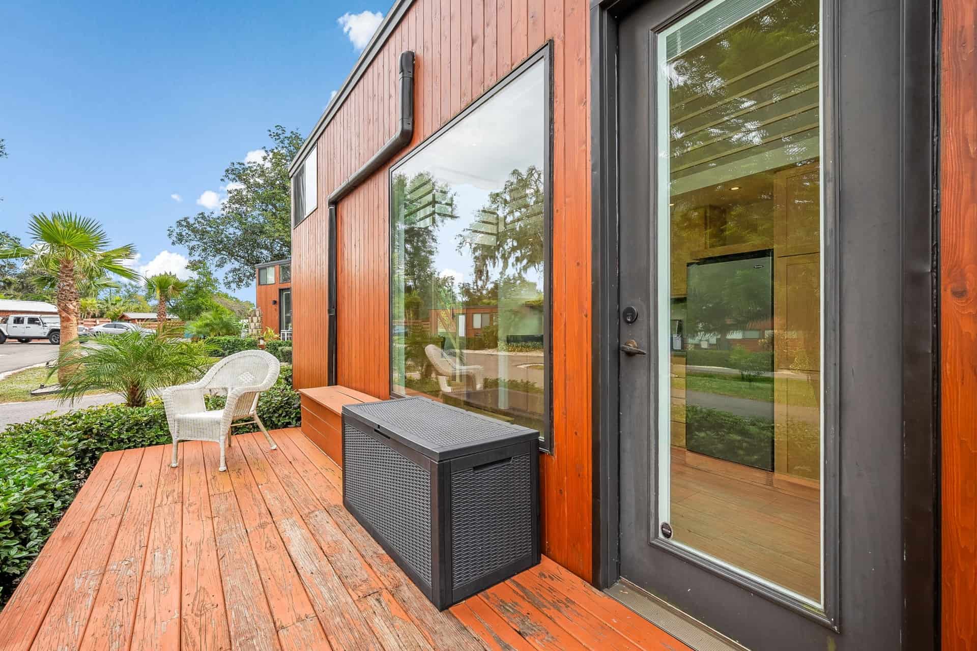 Private wood deck with seating at the Escape One XL tiny home