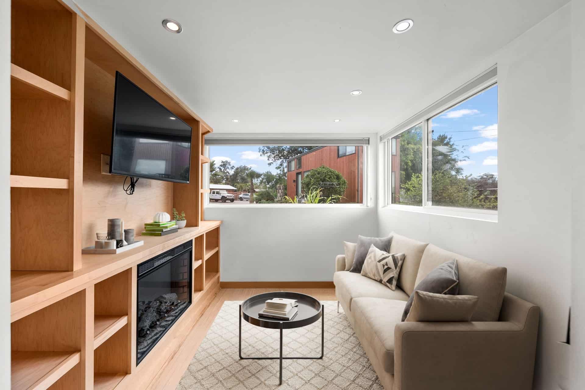 Living area with built-in entertainment center and electric fireplace in the Escape One XL