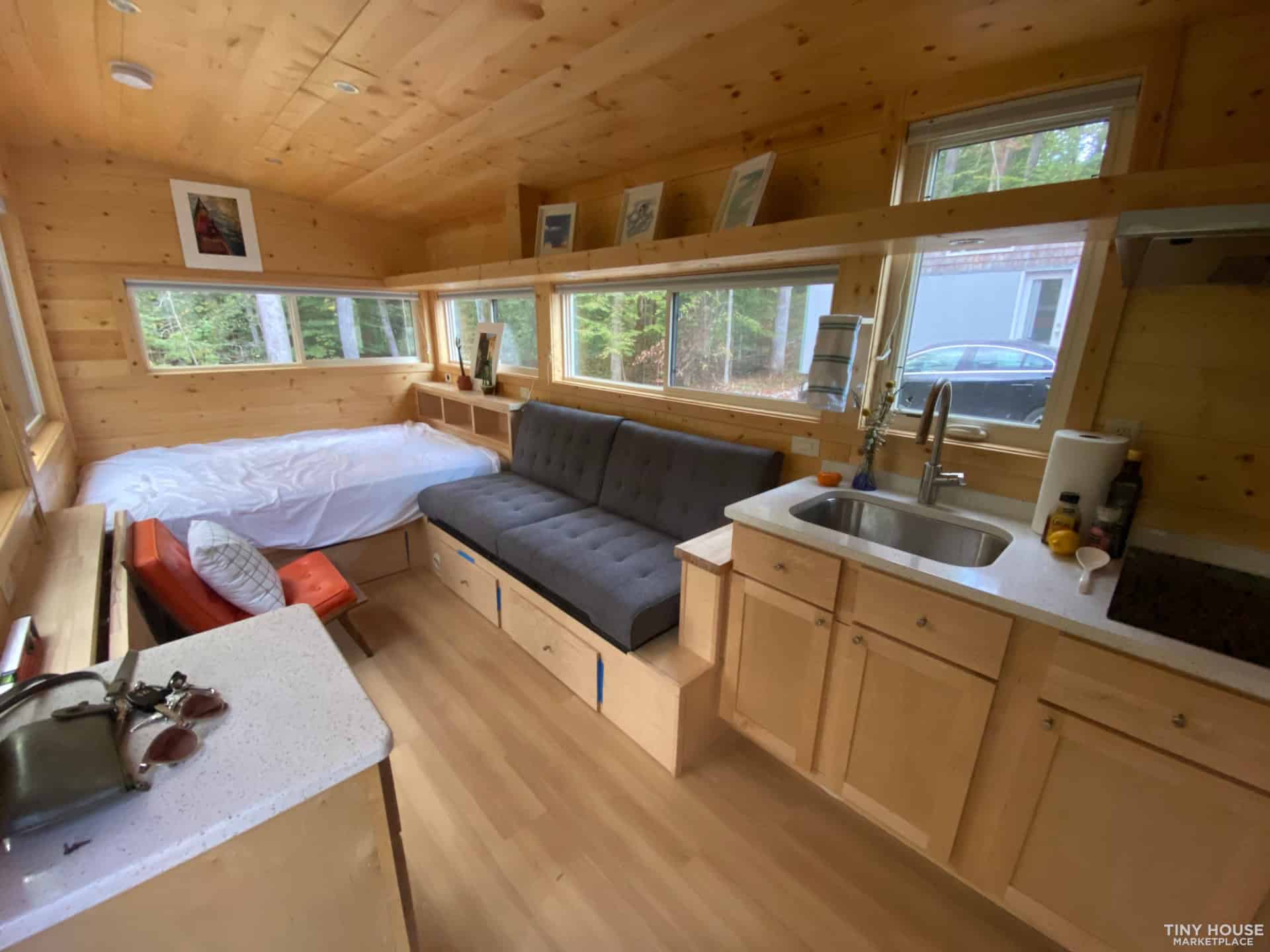Escape Vista Boho interior with wraparound windows, a built-in bed, fold-flat couch and kitchen