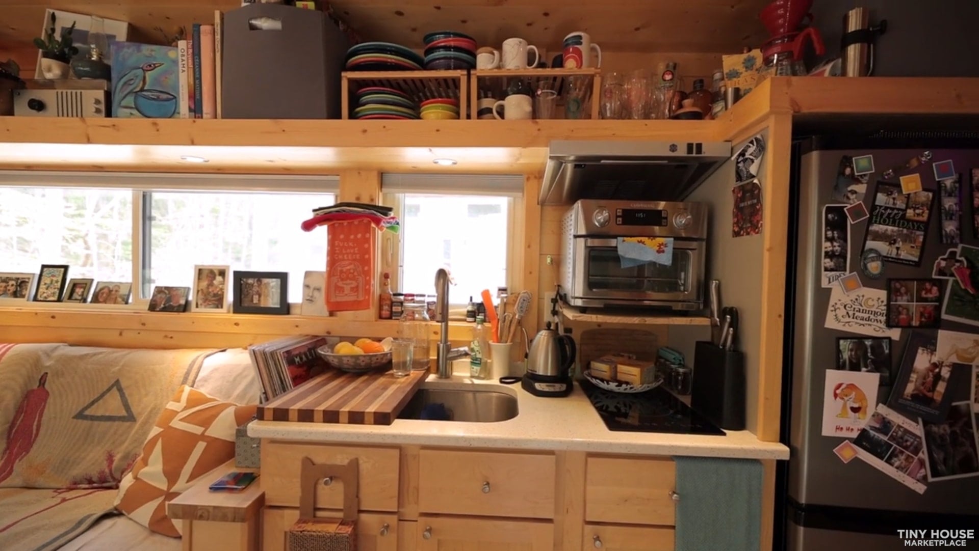 Escape Vista Boho kitchen with white stone counters, deep sink, toaster oven and tall refrigerator