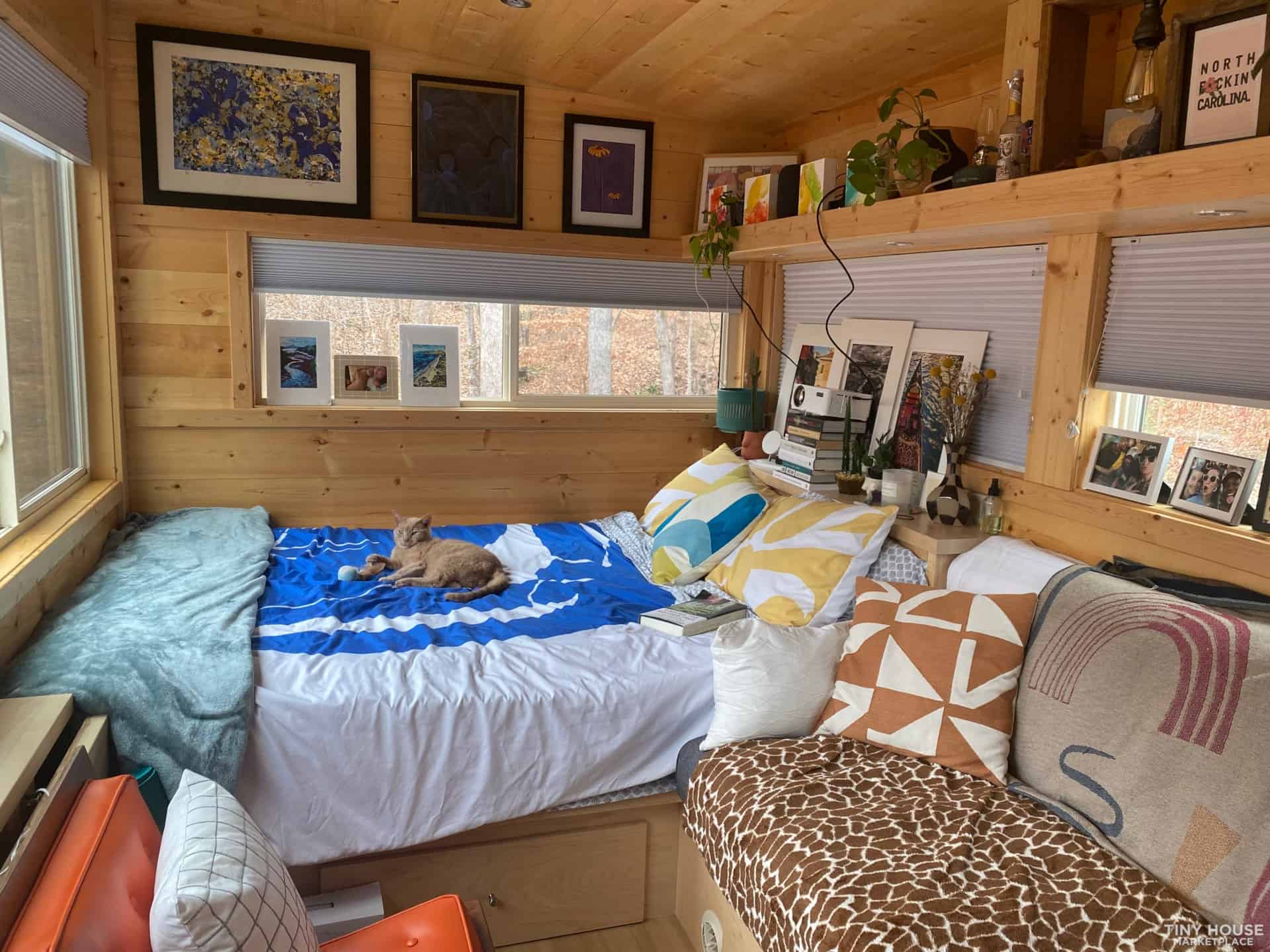 Lived-in Escape Vista Boho with colorful bedding, art on the walls and wraparound windows