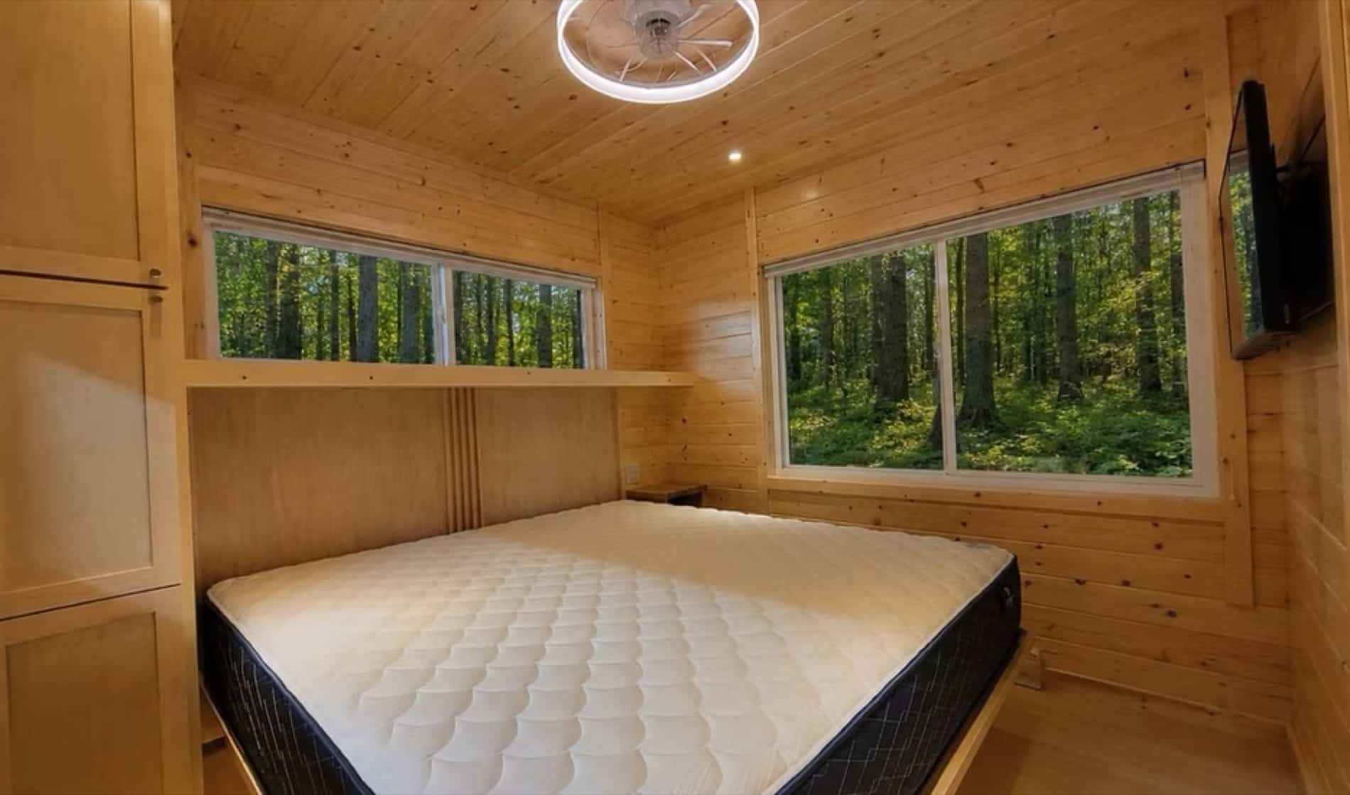 Private bedroom with walkaround King bed in the eVista King Limited tiny house