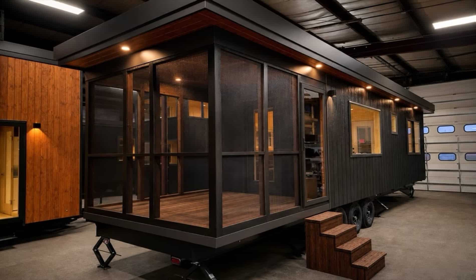 eVista King Limited tiny house exterior with dark siding and screened porch by Escape