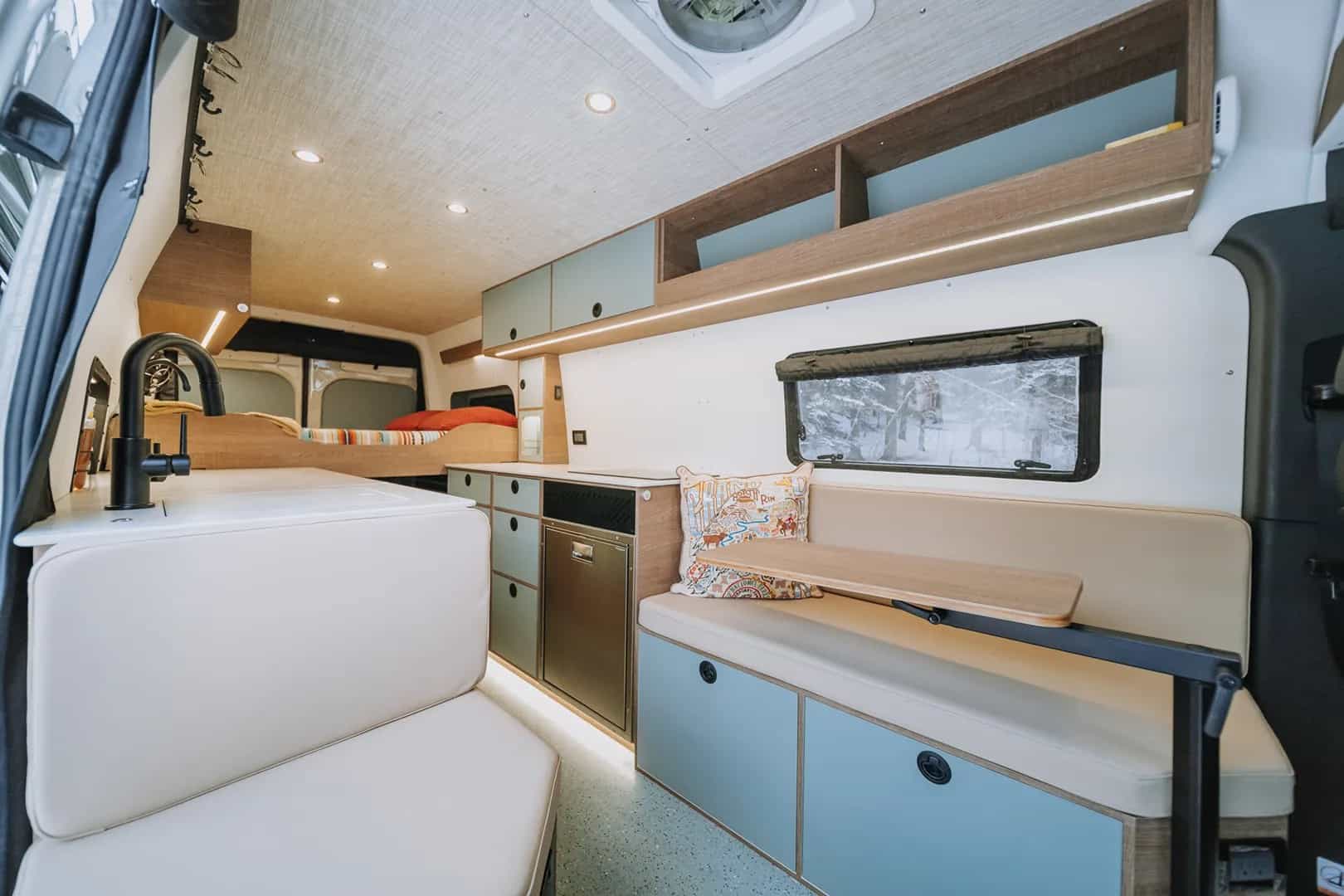 The indoor/outdoor bench seat with storage and workspace in the Fjord camper van