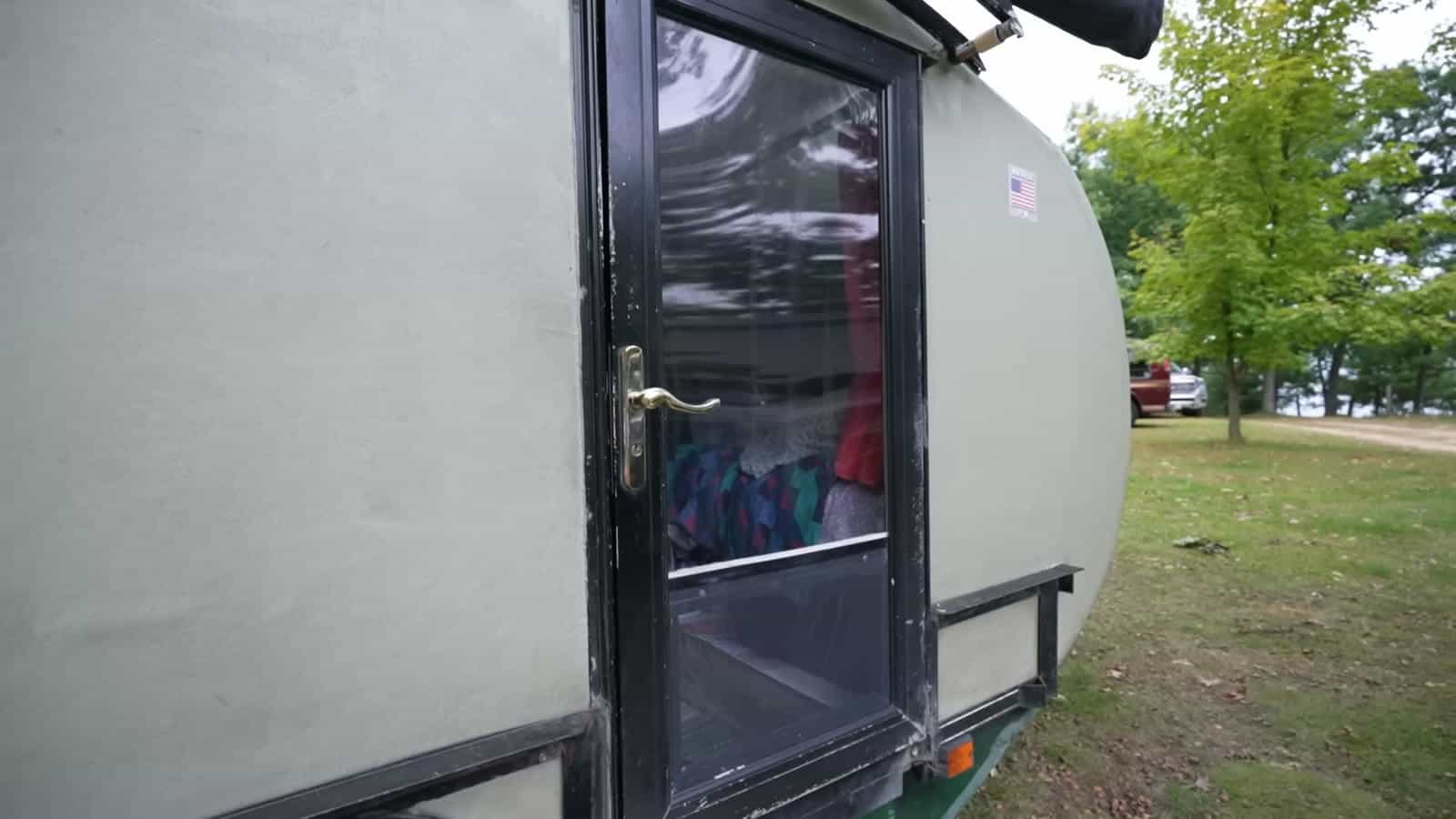 Cut-down full-view storm door on the side of a foam teardrop trailer