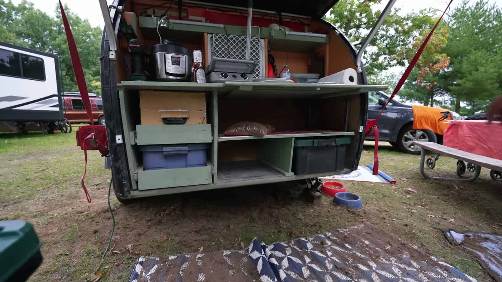 Rear galley of a foam teardrop trailer with a tonneau cover hatch and kitchen gear