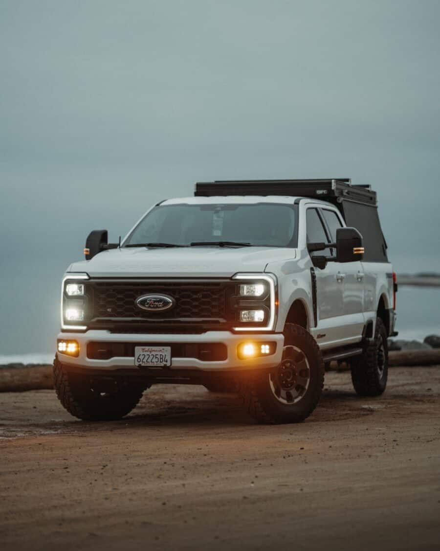 Go Fast Campers V2 Pro closed platform wedge on a white Super Duty pickup at the coast
