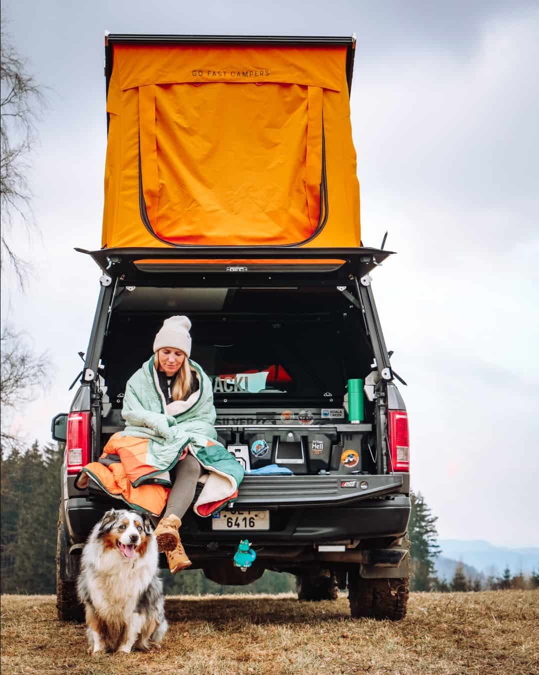 Rear view of Go Fast Campers V2 Pro orange tent open above a lowered truck tailgate