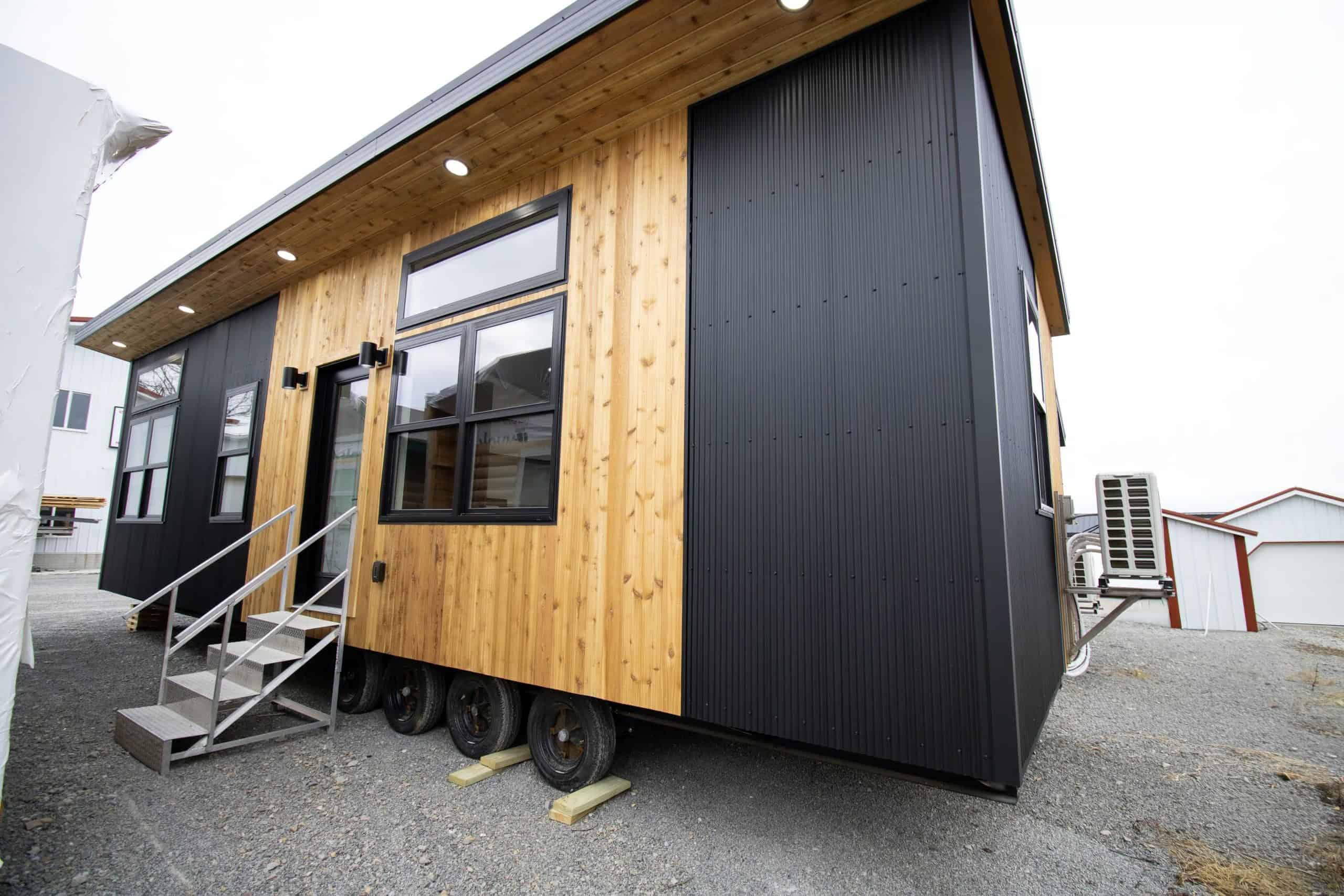 Long side of Modern Twilight: cedar around a full-glass door, black metal, puck lights in the wood soffit, white Bosch condenser at the far end