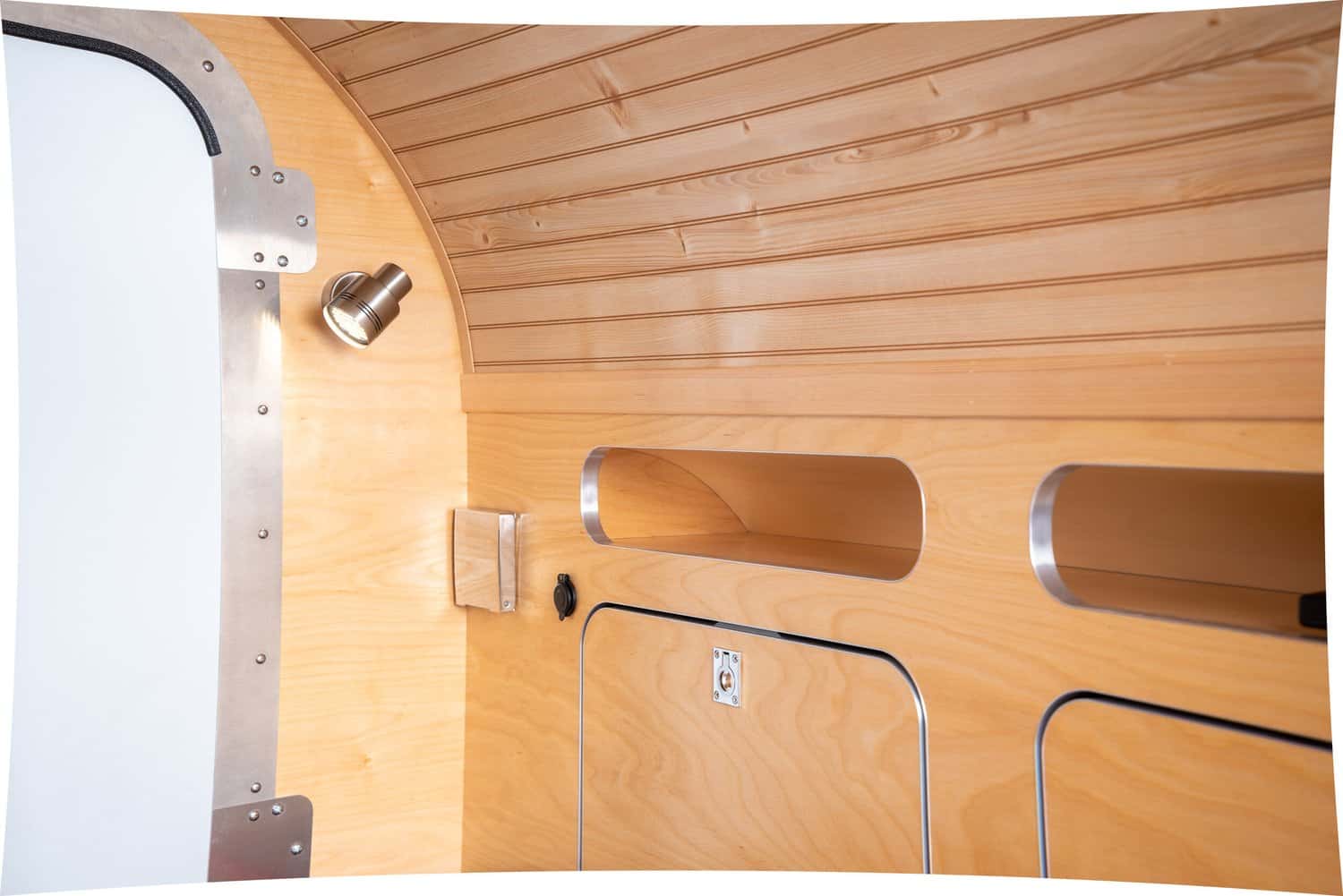 Reading light, cubbies, and storage compartments inside the High Camp teardrop cabin