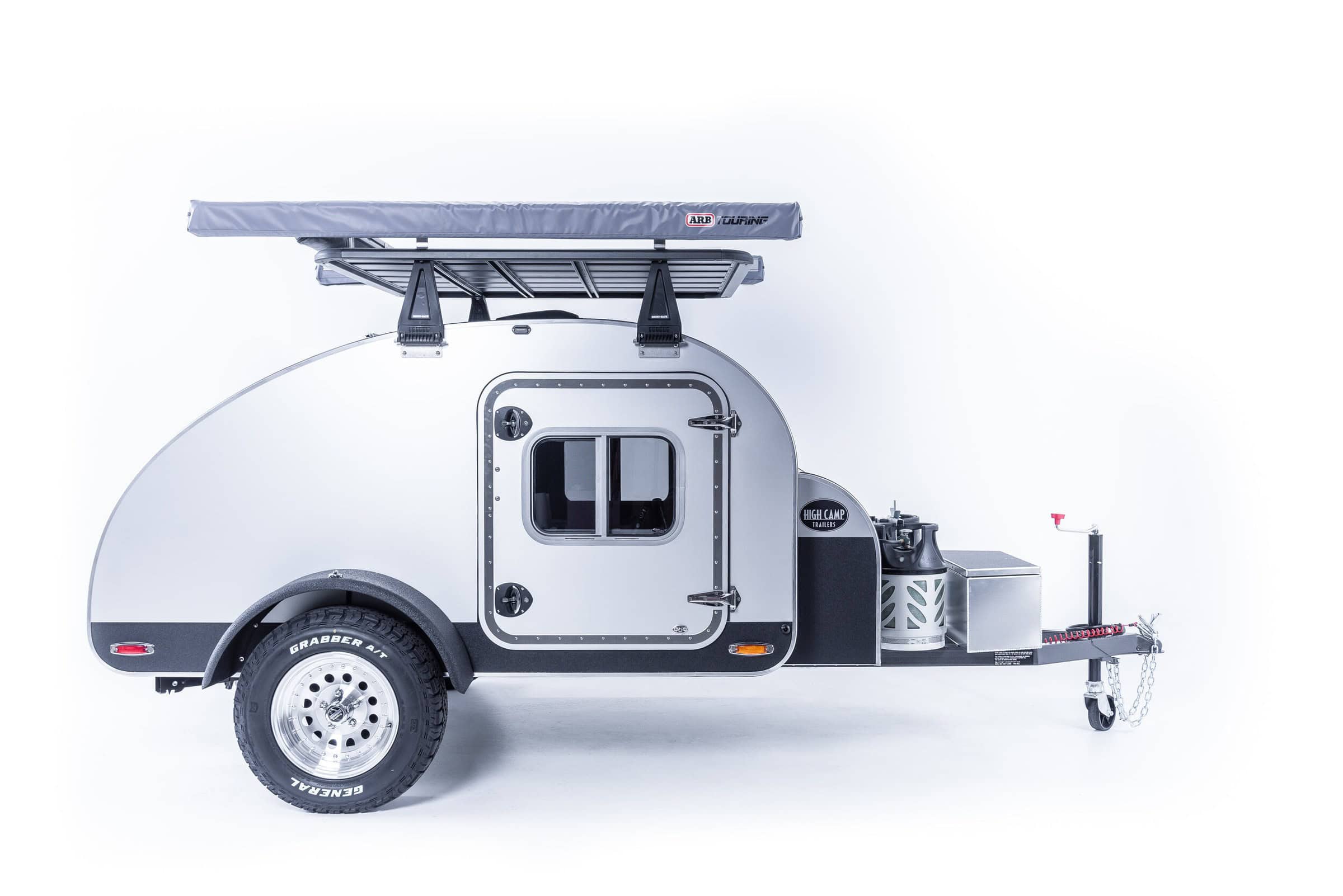 Passenger-side profile of High Camp teardrop with porch-light-ready cabin door and all-terrain tire