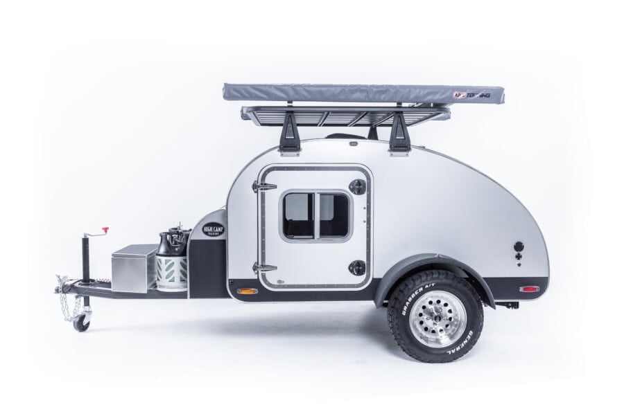 High Camp Trailers teardrop: silver aluminum skin, black lower body, side door, tongue cargo deck and dual propane tanks
