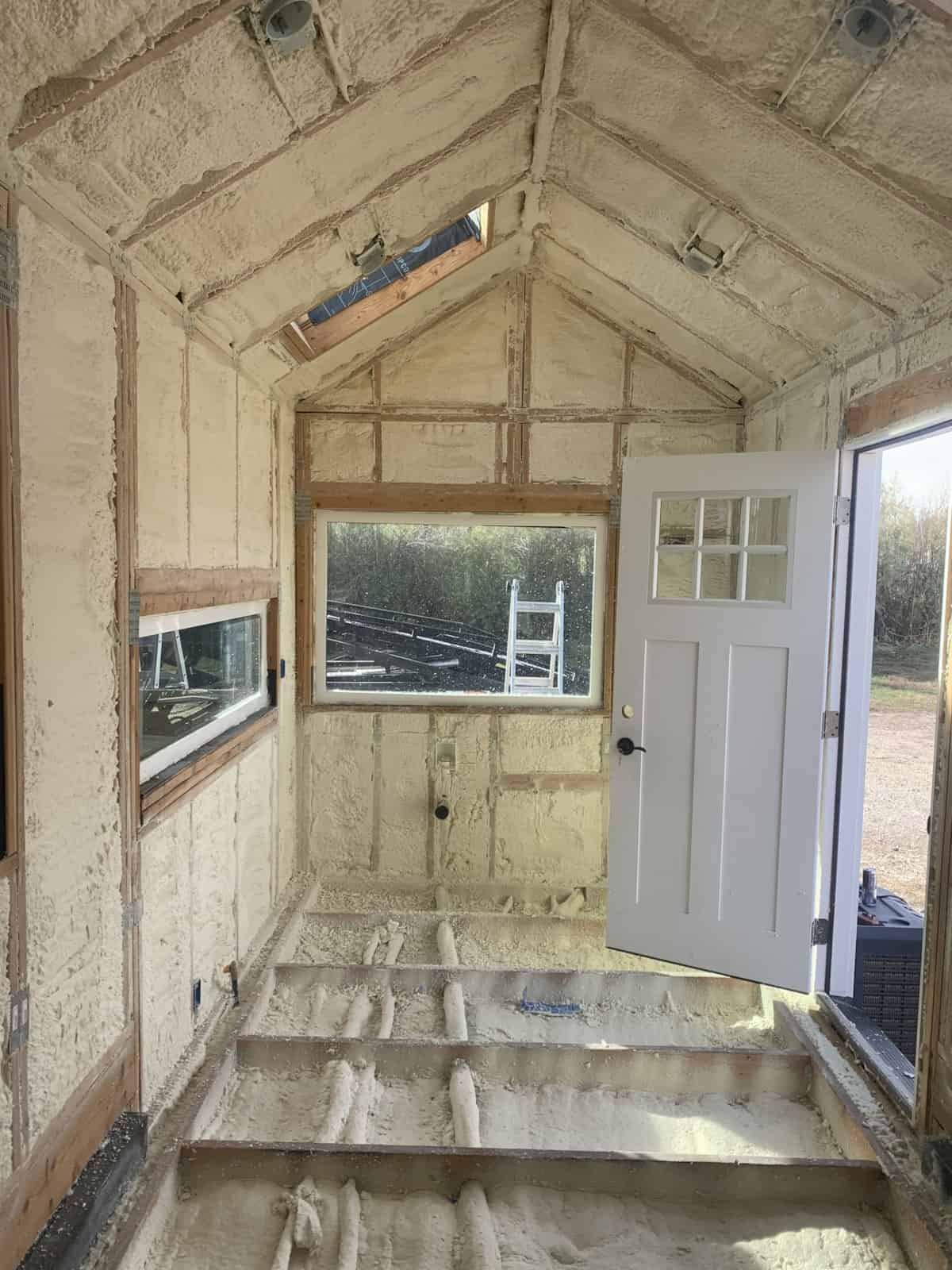 Closed-cell spray foam insulation during construction of the custom tiny house
