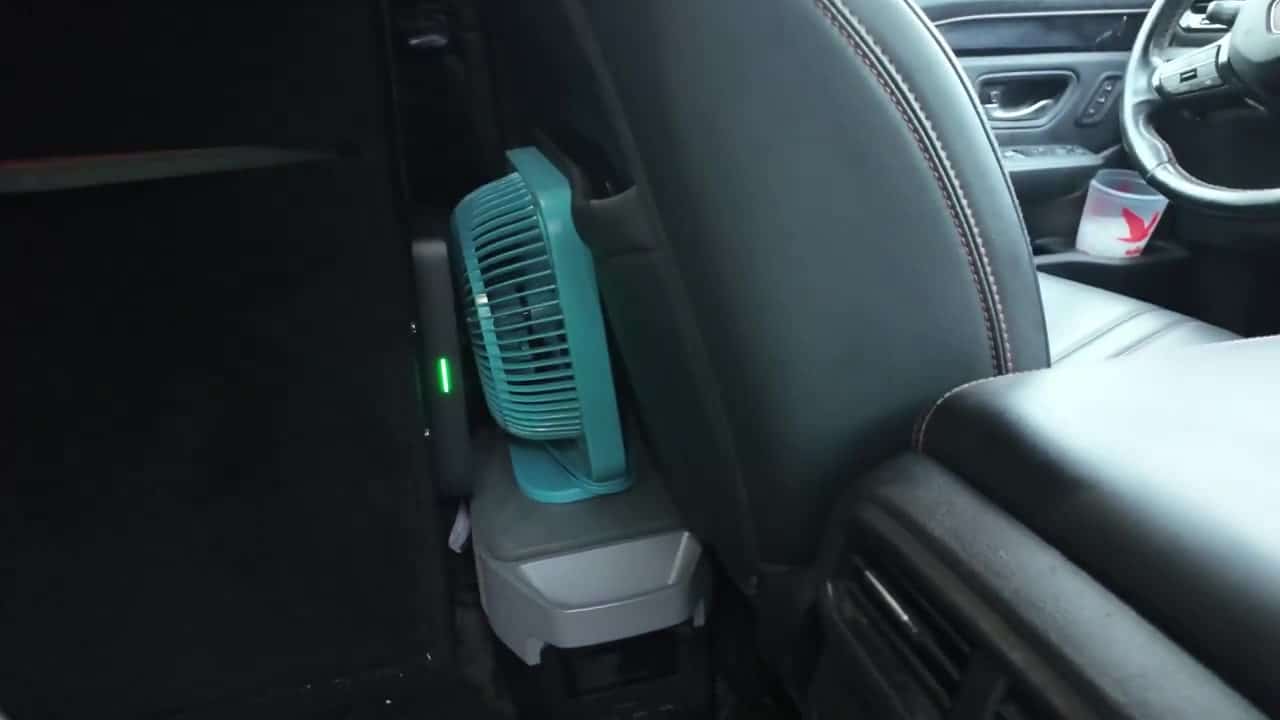 EcoFlow portable power station tucked behind the front passenger seat of Aaron's Honda Pilot TrailSport camper