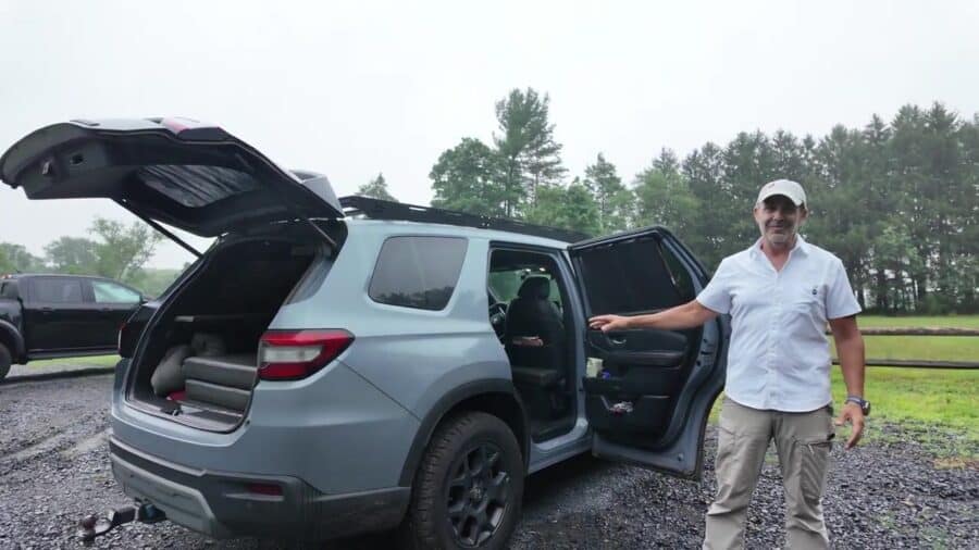 2024 Honda Pilot TrailSport conversion with black roof rack, rear hatch and passenger door open, Aaron presenting the build on a gravel lot