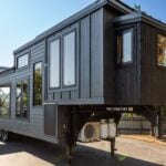 Off-grid tiny home with modern design and mobility features.
