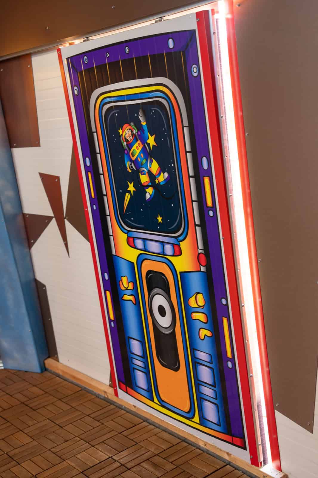 Front door of the UFO Spaceship painted like a rocket hatch with a cartoon astronaut