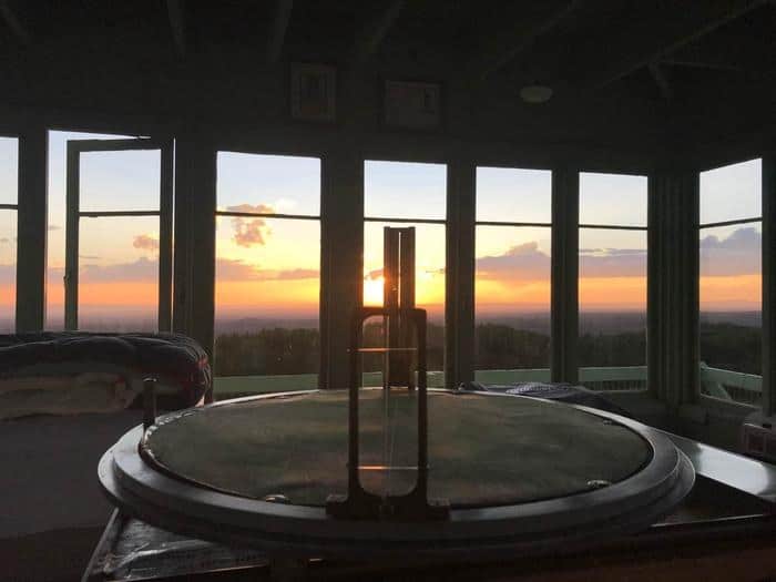 Jersey Jim cab interior: historic fire finder, sunset through 360-degree windows, bed edge