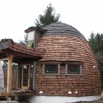 Small round Lexa Dome cabin with natural wood exterior