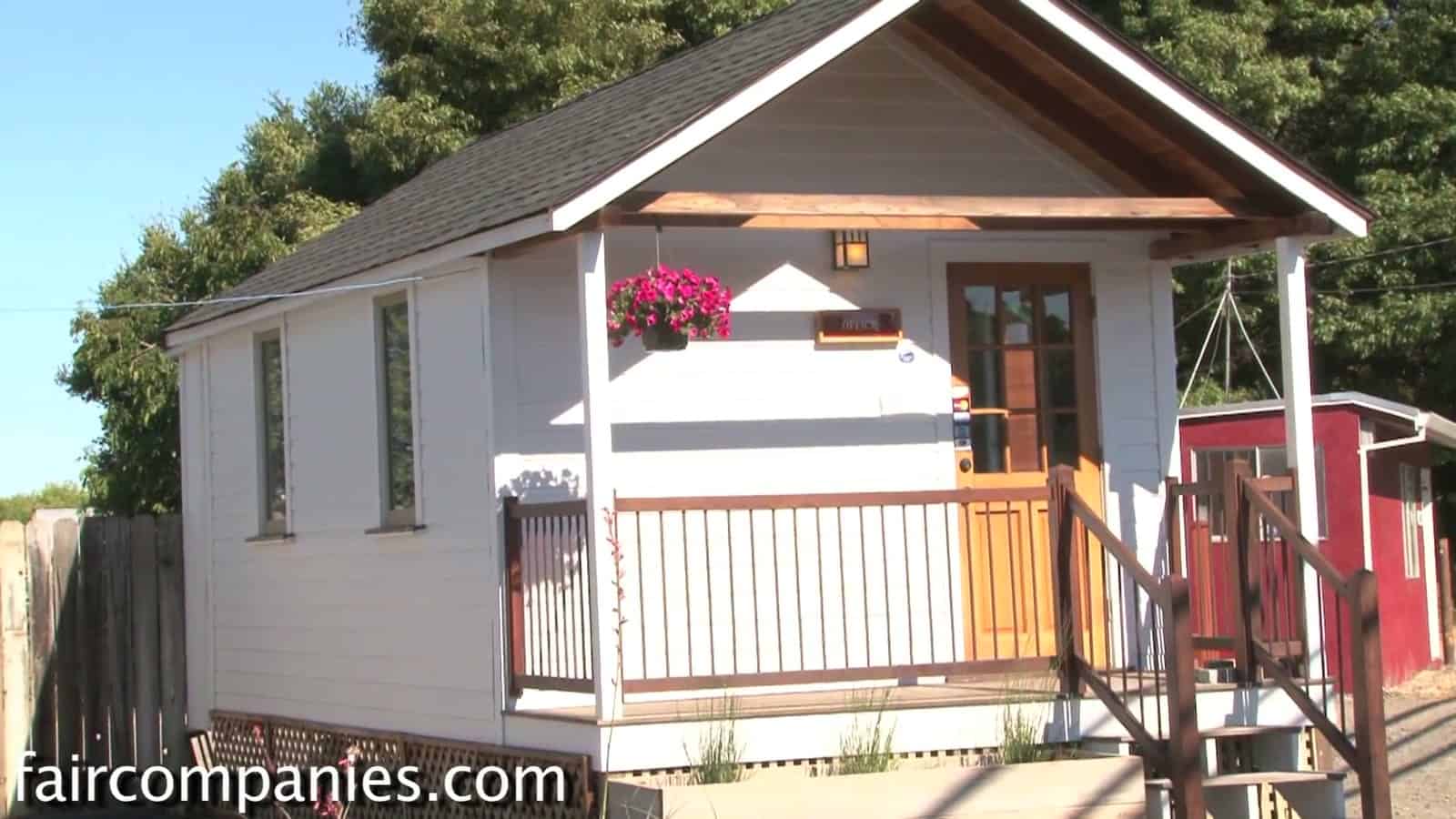 12-foot-wide Little House on a Trailer with white siding, covered front porch and hanging flower basket in Petaluma, California