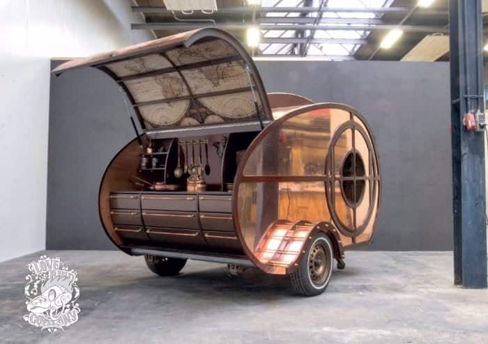 Copper-clad steampunk teardrop trailer by The Love Bird Company with the rear galley hatch open
