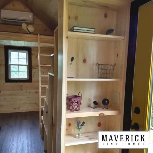 Maverick Quantum interior: pine tongue-and-groove, loft ladder, built-in pine shelving, yellow door edge, mini-split on the loft wall