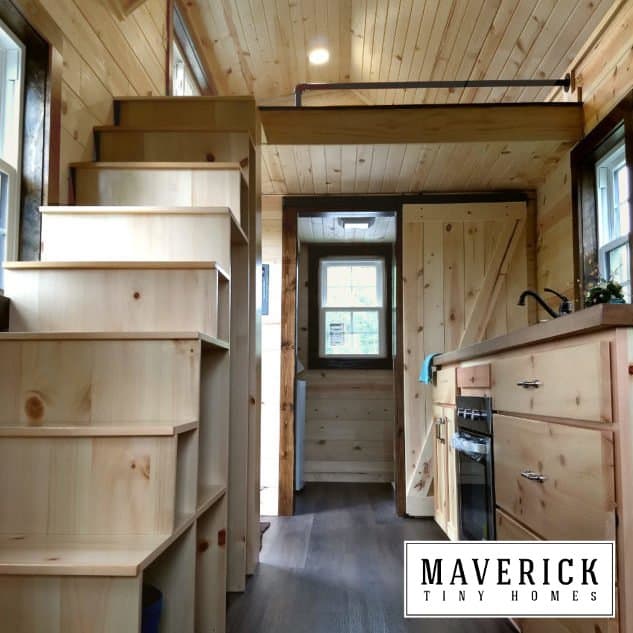Maverick Quantum gallery interior showing storage stairs, pine walls, kitchen with butcher-block, loft rail — stairs print for 18 ft and up